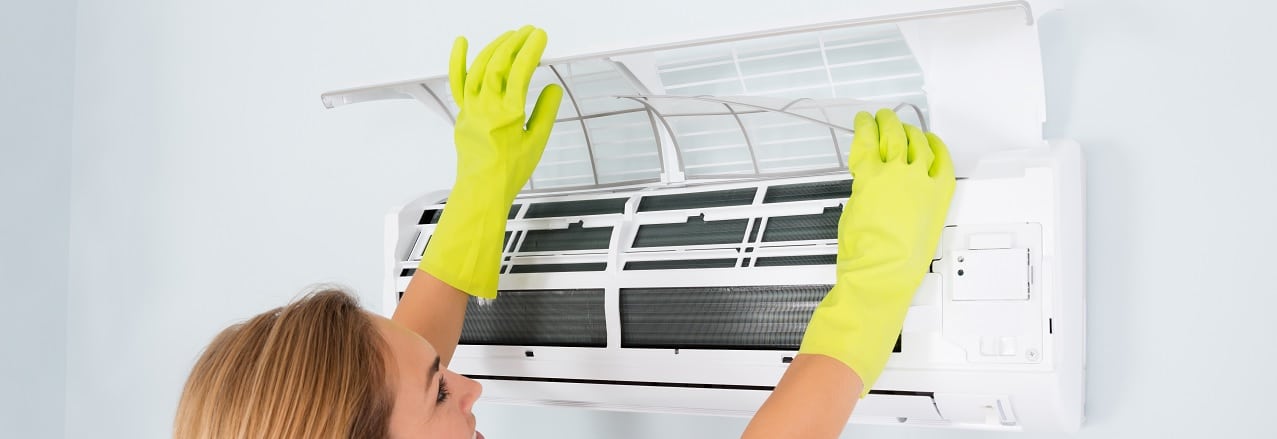 Woman checking her room air conditioner