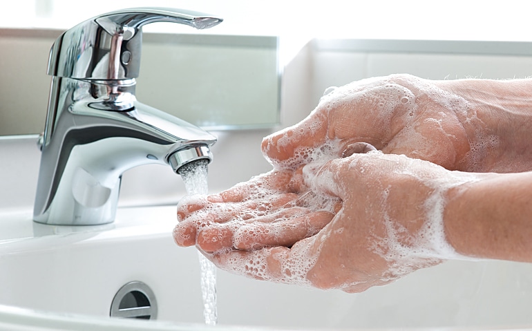 washing hands with soap under water