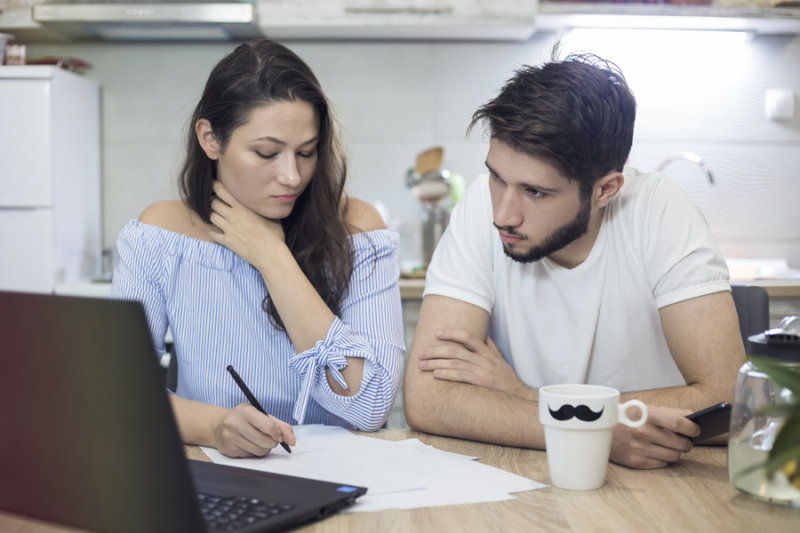 Couple on laptop researching high efficiency heat pumps. Superior Heating Cooling Plumbing blog image.